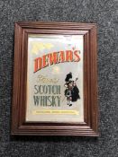 A framed Dewars Finest Scotch Whiskey advertising mirror