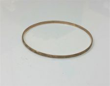 A 9ct gold bangle,