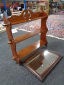 An Edwardian mahogany wall shelf (missing 3 pegs) and an oak framed mirror