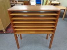A set of mid 20th century teak draughtsman shelves on raised legs