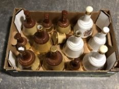 Thirteen empty Bells Whisky decanters