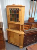 A blond oak leaded glass door corner cabinet