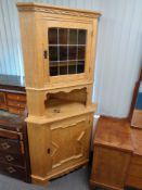 A blond oak leaded glass door corner cabinet