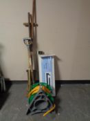 A bundle of garden tools together with a hose pipe on reel and a boxed adjustable fender