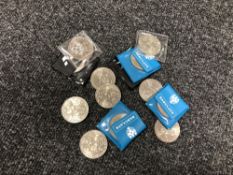 A collection of thirteen commemorative crowns.