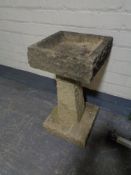 A composite pedestal bird bath