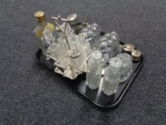 A tray of cruet set on plated stand, three vintage glass jelly moulds, perfume bottle,