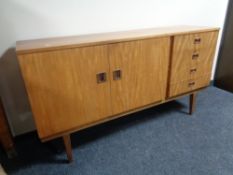 A mid 20th century six piece teak dining room suite comprising of sideboard,