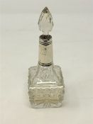 A silver-collared perfume bottle,