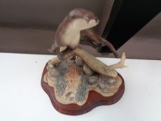 A Border Fine Arts figure of an otter on driftwood,