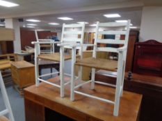 A pair of painted kitchen rush seated armchairs