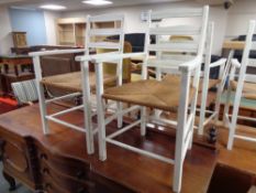 A pair of painted rush seated kitchen armchairs