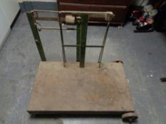 A vintage set of grain weighing scales on metal wheels