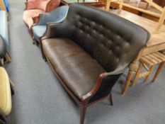 A 20th century mahogany framed shaped back settee upholstered in a black fabric , height 92 cm,