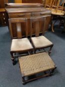 A pair of Edwardian oak dining chairs and a stained pine rush seated stool