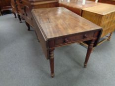 A Victorian mahogany drop leaf table fitted a drawer