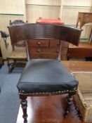 An antique oak elbow chair