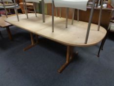 A late 20th century oval pine extending refectory dining table with leaf