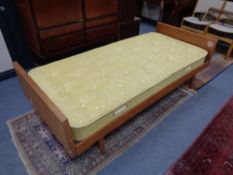 A mid 20th century teak 3' bed frame with interior