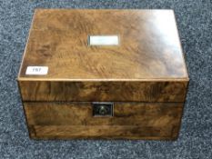 A 19th century walnut mother of pearl inlaid travel vanity box of five glass jars and bottles