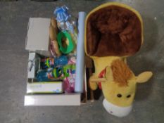 A toddler soft rocking toy together with a box containing new children;