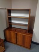 A mid 20th century Danish double door cabinet together with matching bookshelves