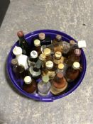A tub of assorted whisky miniatures