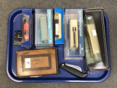 A tray of die cast cars, folding knife,