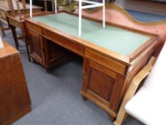 An antique pine twin pedestal writing desk fitted three drawers with leather inset panel