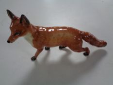 A large Beswick figure, fox walking.