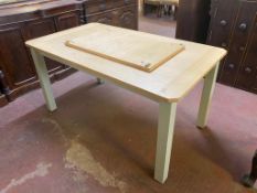 A contemporary extending dining table on painted legs