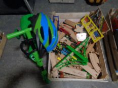 A crate containing scuttlebug with helmet, large quantity of wooden train track trains,