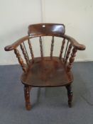 An antique oak captain's armchair
