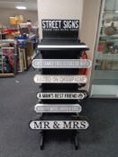 A shop display stand containing thirty contemporary signs
