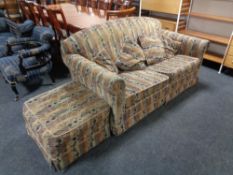 An Edwardian two seater settee and matching footstool