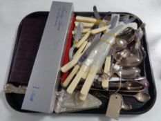 A tray of assorted flatware, butter knives, cake servers, plated and silver teaspoons,