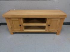 A contemporary entertainment stand fitted cupboards and shelves