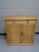 An antique pine double door low cupboard