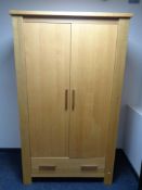 A contemporary oak double door wardrobe
