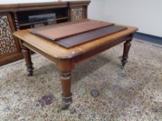 A Victorian mahogany extending dining table with three leaves