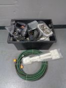 A plastic box of hose pipe, brass lion mask door knocker, paint stripper,