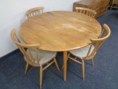 An Ercol solid elm and beech circular flap sided dining table, catalogue no.