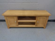 A contemporary entertainment stand fitted cupboards and shelves (a/f)