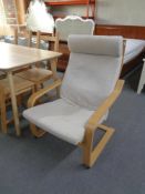 A wooden framed Ikea relaxer armchair