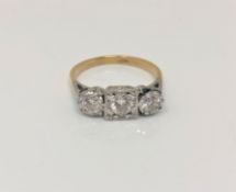 An 18ct gold three stone diamond ring, the three brilliant cut stones approximately 1ct,