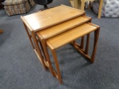 A nest of three mid 20th century teak G Plan tables