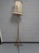 A brass Art Nouveau standard lamp with shade