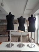 Three dress maker's mannequins on metal stands