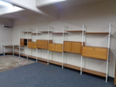 A mid 20th century seven bay teak Ladderax modular unit together with corner stand