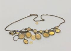 An antique silver and moonstone necklace (some pieces loose but present)